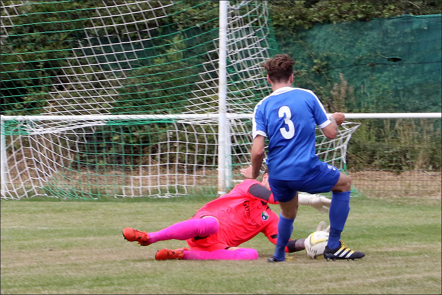 The Colney Keeper dives bravely to deny tom Inch