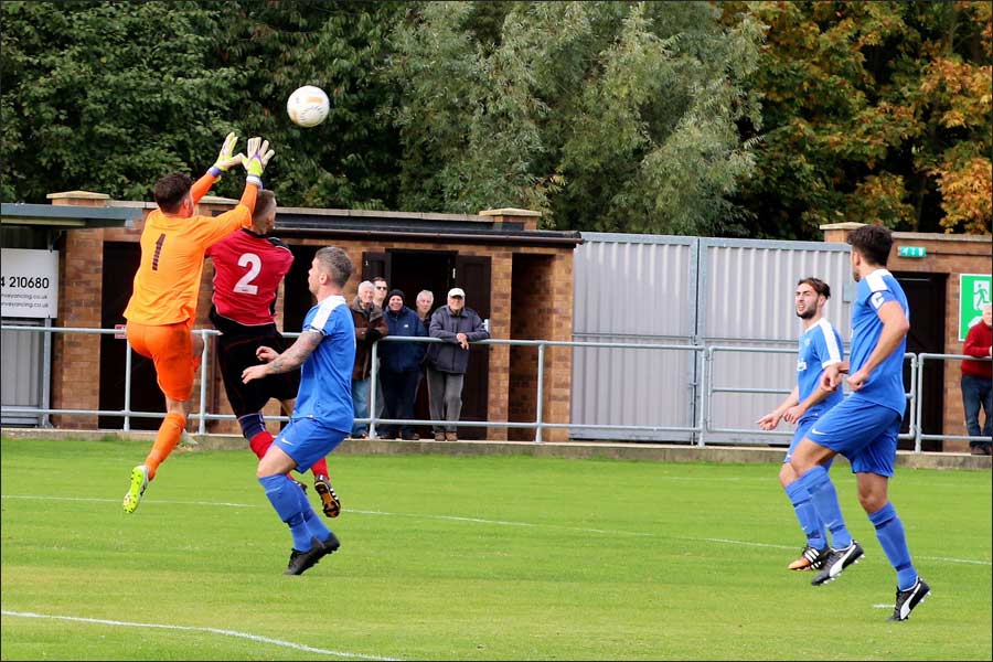 The collision as Rob Partington leaps for the ball